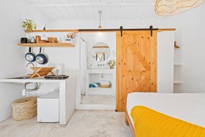 a room with a bed and a wooden door at Downtown SURF SHACK- steps from main surf break in Sayulita