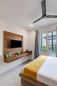 a bedroom with a large bed and a flat screen tv at Hotel Travana Stay at Pitampura in New Delhi