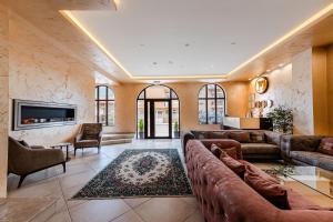 a large living room with couches and a tv at Ardo Spa Hotel and Restaurant in Sarnitsa