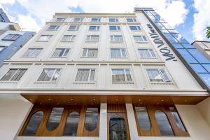 a white building with the word hotel on it at Monday Premium Madhapur in Hyderabad