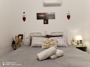 a bedroom with a bed with two pillows on it at Seleucia DaR Umm Qais in Um Qeis
