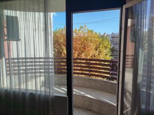 a glass door with a view of a balcony at apartman capljinka in Čapljina +6 photos