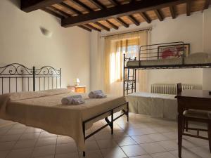a bedroom with two bunk beds and a desk at Affittacamere La Mattonata in Città di Castello