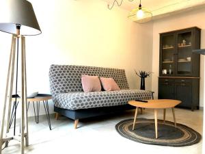 a living room with a couch and a table at Le Sémillon in Bandol +23 photos