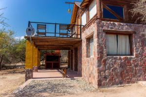 a dog is standing outside of a building at Cabañas en Nono La Soñada in Nono
