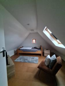 a bedroom with a bed and a couch in a attic at Nordlicht in Hagen im Bremischen