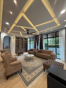 a living room with couches and a table at The Garden Twelve Homestay in Putrajaya