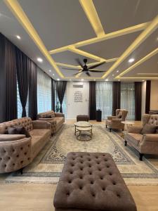 a large living room with couches and a ceiling at The Garden Twelve Homestay in Putrajaya