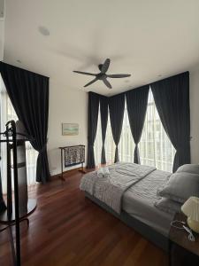 a bedroom with a bed and a ceiling fan at The Garden Twelve Homestay in Putrajaya