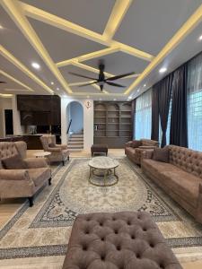 a living room with couches and a table at The Garden Twelve Homestay in Putrajaya +26 photos