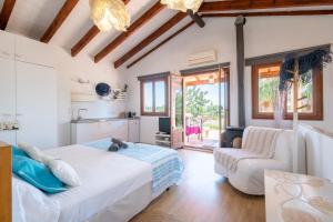 a bedroom with a bed and a living room at Alegrías in Pla de na Tesa +26 photos