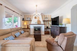 a living room with a couch and a fireplace at Alegrías in Pla de na Tesa