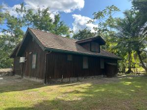 a small wooden building with a roof at Howler Landing Vacation Rental in Bermudian Landing