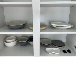a shelf with bowls and other bowls and plates at Slow, gaebong in Seoul +34 photos