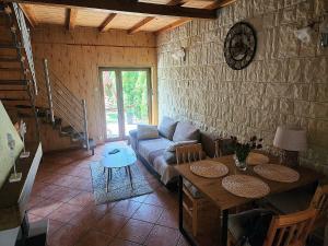 a living room with a couch and a table at Nad Miedwinką - Dom in Morzyczyn