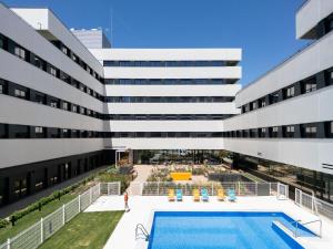 an external view of a building with a pool at Student Experience Granada - Luxury Hostel in Granada