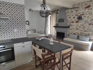 a kitchen with a table and chairs in a room at Charming Apartments in Trikeri Village in Tríkeri