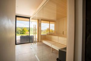 a room with a sauna with a large window at Aux mélèzes de Xavier GÎTE 4 étoiles in Wangenbourg +45 photos
