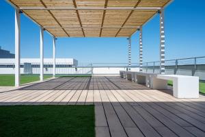 a large deck with benches on the roof of a building at Student Experience Granada - Luxury Hostel in Granada