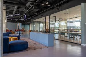 an open office with chairs and tables and windows at Student Experience Granada - Luxury Hostel in Granada +10 photos