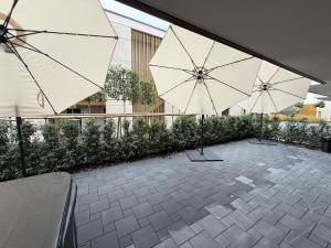 a group of umbrellas sitting on a patio at KaiserLogen Wellness in Kaisersesch