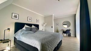 a bedroom with a large bed and a desk at Landhaus Lotten in Winsen Luhe