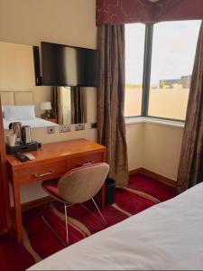 Ένα ή περισσότερα κρεβάτια σε δωμάτιο στο ICON Hotel