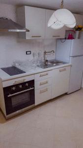 a kitchen with a stove and a sink in it at Casa Tre in Mussomeli