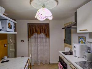 a kitchen with a light hanging from a ceiling at Casa Tre in Mussomeli
