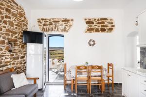 a kitchen and dining room with a table and chairs at Olga's House Kythnos in Kithnos