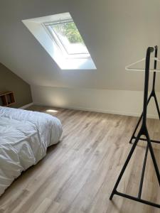 a bedroom with a bed and a skylight at Charming House in Beauvais in Beauvais +3 photos