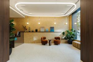 a lobby with two chairs and a table at Atipico Madrid in Madrid