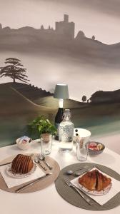 a table with a plate of food and a bottle of water at B&B Le Albarelle in Alba