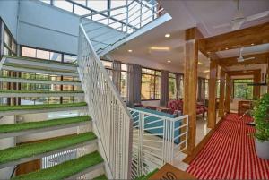 a staircase in a building with grass on the stairs at The Panakal Boho in Cochin