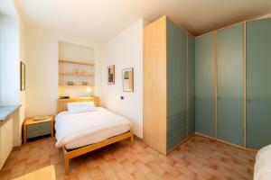 a small bedroom with a bed and a closet at Casa Tua Lake Maggiore in Castelletto sopra Ticino
