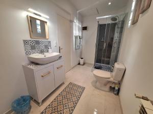 a bathroom with a toilet and a sink and a shower at Le Clairat in Saint-Michel-Saint-Jaymes