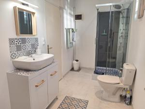 a bathroom with a toilet and a sink and a shower at Le Clairat in Saint-Michel-Saint-Jaymes