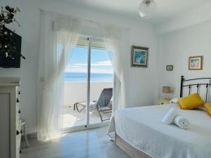 a bedroom with a bed and a view of the ocean at Vistas al mar - La Herradura in La Herradura +33 photos