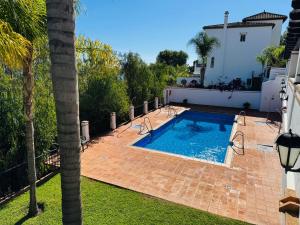a swimming pool in the backyard of a house at Vistas al mar - La Herradura in La Herradura