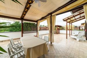 a patio with a table and chairs on a balcony at Casa Tua Lake Maggiore in Castelletto sopra Ticino