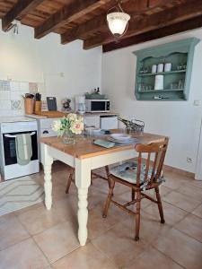 a kitchen with a table and chairs in a room at Le Clairat in Saint-Michel-Saint-Jaymes +14 photos