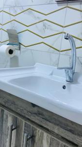 a sink with a faucet in a bathroom at Wadi Rum Abu Khaled in Wadi Rum +92 photos