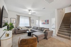 a living room with a couch and a staircase at Venice, Large Modern 5BRMs, 2 Living RMs, Parking, Close to Dallas Downtown in Dallas