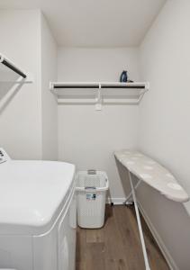 a white bathroom with a sink and a bench at Venice, Large Modern 5BRMs, 2 Living RMs, Parking, Close to Dallas Downtown in Dallas +42 photos