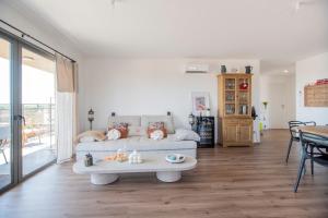 a living room with a couch and a table at 2 bedroom Sun & Terrace with sea view in San-Nicolao +8 photos