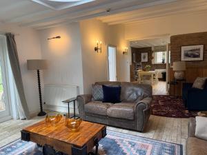 a living room with a couch and a coffee table at The Gatehouse at Pudleston Court in Hatfield