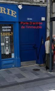 a blue gas station with a blue door at Appartement Au Quai 1921 in Besançon