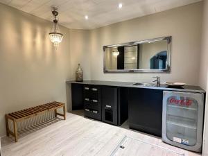 Ein Badezimmer im Coca-Cola-Stil mit Waschbecken und Spiegel in der Unterkunft Villa Ateljeerinne in Jyväskylä + 23 Fotos