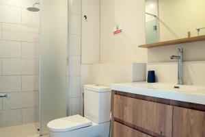 a bathroom with a toilet and a sink at Serenity Pool Villa at Azuri in Roches Noires