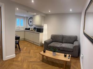 a living room with a couch and a table at Little Dunton Lodges 1 in Little Burstead